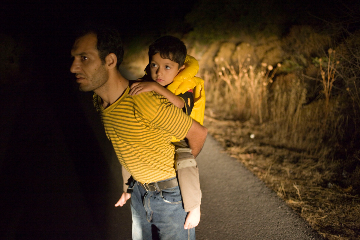 PAR374697 On the road at night, a small family of illegal immigrants which fled the Taliban, has succeeded to cross the Egean sea from the Turkish border and reached Lesvos.Island of Lesvos. Greece. 2009. © Patrick Zachmann / Magnum Photos