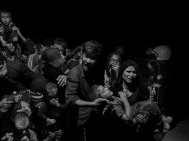 Scene #0410.
GREECE. Lesbos. Mytilene. 2015. Refugees and migrants arriving on Lesbos are transferred to the Moria refugee camp where they register with authorities before being able to move on.